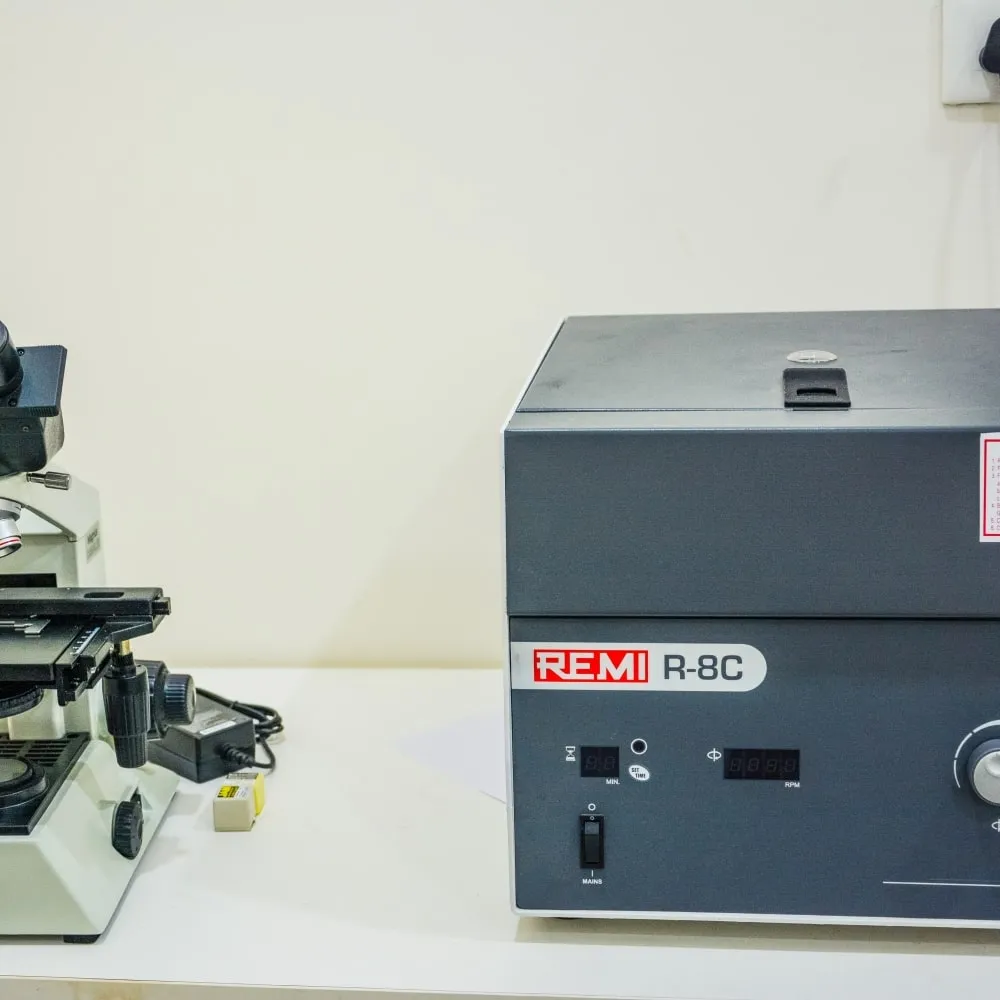 Microscope and centrifuge in the laboratory at AMVI Hospitals