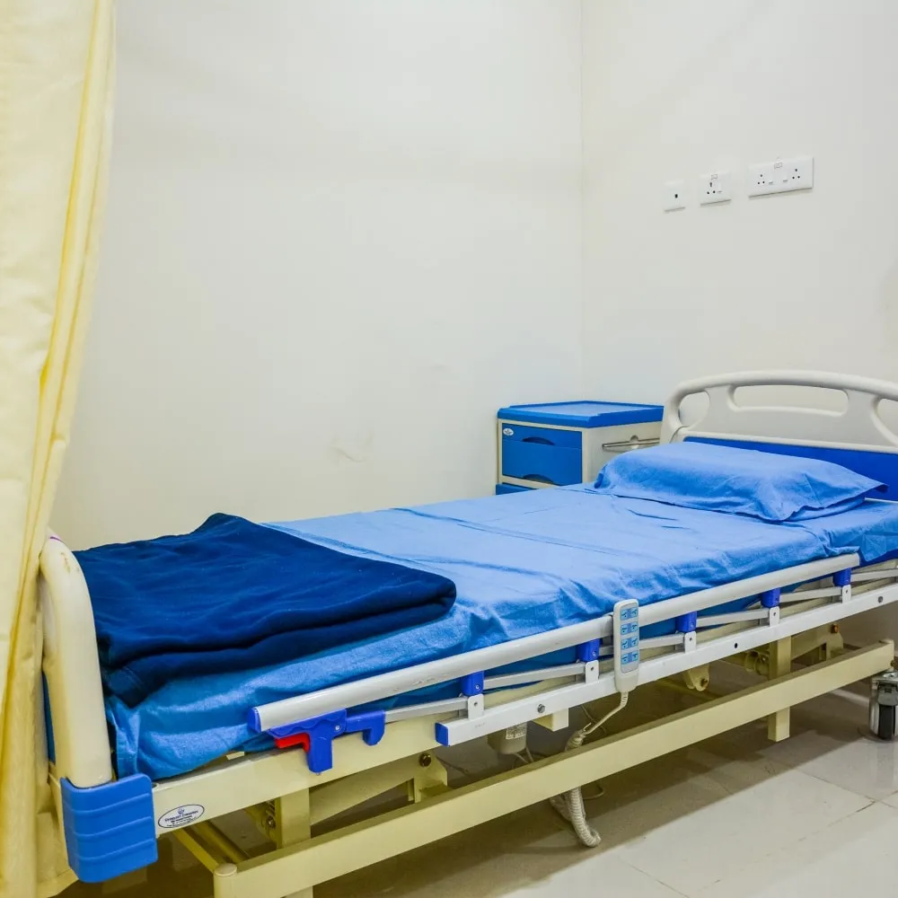 Patient bed in a private room at AMVI Hospitals